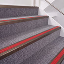Dark Bronze double insert chevron stair nosing, 40mm riser with Red inserts, fitted on carpeted stairs