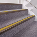 Dark Bronze double insert chevron stair nosing, 40mm riser with Yellow inserts, fitted on carpeted stairs