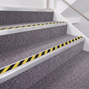 Mill Finish double insert chevron stair nosing, 40mm riser with Hazard black and yellow inserts, fitted on carpeted stairs