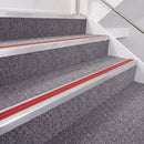 Mill Finish double insert chevron stair nosing, 40mm riser with Red inserts, fitted on carpeted stairs