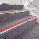 Mirrorflect Silver double insert chevron stair nosing, 40mm riser with Red inserts, fitted on carpeted stairs