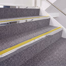Mirrorflect Silver double insert chevron stair nosing, 40mm riser with Yellow inserts, fitted on carpeted stairs