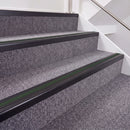 Satin Black double insert chevron stair nosing, 40mm riser with Dark Green inserts, fitted on carpeted stairs