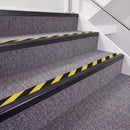 Satin Black double insert chevron stair nosing, 40mm riser with Hazard black and yellow inserts, fitted on carpeted stairs