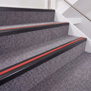 Satin Black double insert chevron stair nosing, 40mm riser with Red inserts, fitted on carpeted stairs