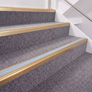 Satin Bronze double insert chevron stair nosing, 40mm riser with Aura inserts, fitted on carpeted stairs