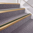 Satin Bronze double insert chevron stair nosing, 40mm riser with Dark Green inserts, fitted on carpeted stairs