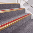 Satin Bronze double insert chevron stair nosing, 40mm riser with Red inserts, fitted on carpeted stairs