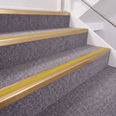 Satin Bronze double insert chevron stair nosing, 40mm riser with Yellow inserts, fitted on carpeted stairs