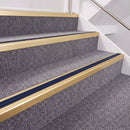 Satin Gold double insert chevron stair nosing, 40mm riser with Dark Blue inserts, fitted on carpeted stairs