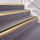 Satin Gold double insert chevron stair nosing, 40mm riser with Dark Green inserts, fitted on carpeted stairs
