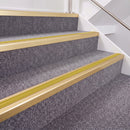 Satin Gold double insert chevron stair nosing, 40mm riser with Yellow inserts, fitted on carpeted stairs