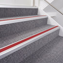 Satin Silver double insert chevron stair nosing, 40mm riser with Red inserts, fitted on carpeted stairs