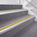 Satin Silver double insert chevron stair nosing, 40mm riser with Yellow inserts, fitted on carpeted stairs