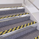 Bright Polished double insert chevron stair nosing, 60mm riser with Hazard black and yellow inserts, fitted on carpeted stairs