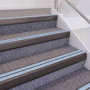 Dark Bronze double insert chevron stair nosing, 60mm riser with Aura inserts, fitted on carpeted stairs