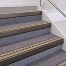 Dark Bronze double insert chevron stair nosing, 60mm riser with Beige inserts, fitted on carpeted stairs