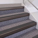 Dark Bronze double insert chevron stair nosing, 60mm riser with Dark Grey inserts, fitted on carpeted stairs