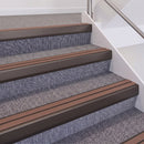 Dark Bronze double insert chevron stair nosing, 60mm riser with Mid Brown inserts, fitted on carpeted stairs