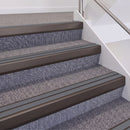 Dark Bronze double insert chevron stair nosing, 60mm riser with Mid Grey inserts, fitted on carpeted stairs