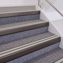Dark Bronze double insert chevron stair nosing, 60mm riser with Oyster inserts, fitted on carpeted stairs