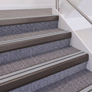 Dark Bronze double insert chevron stair nosing, 60mm riser with Polar Grey inserts, fitted on carpeted stairs