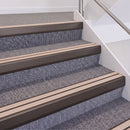 Dark Bronze double insert chevron stair nosing, 60mm riser with Sahara inserts, fitted on carpeted stairs
