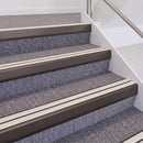 Dark Bronze double insert chevron stair nosing, 60mm riser with White inserts, fitted on carpeted stairs