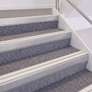 Mill Finish double insert chevron stair nosing, 60mm riser with White inserts, fitted on carpeted stairs