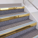 Mirrorflect Gold double insert chevron stair nosing, 60mm riser with Aura inserts, fitted on carpeted stairs