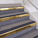 Mirrorflect Gold double insert chevron stair nosing, 60mm riser with Dark Blue inserts, fitted on carpeted stairs