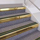 Mirrorflect Gold double insert chevron stair nosing, 60mm riser with Dark Green inserts, fitted on carpeted stairs