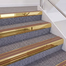 Mirrorflect Gold double insert chevron stair nosing, 60mm riser with Mid Brown inserts, fitted on carpeted stairs