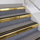 Mirrorflect Gold double insert chevron stair nosing, 60mm riser with Premium Black inserts, fitted on carpeted stairs