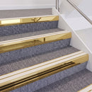 Mirrorflect Gold double insert chevron stair nosing, 60mm riser with White inserts, fitted on carpeted stairs