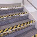 Mirrorflect Silver double insert chevron stair nosing, 60mm riser with Hazard black and yellow inserts, fitted on carpeted stairs