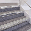 Mirrorflect Silver double insert chevron stair nosing, 60mm riser with Oyster inserts, fitted on carpeted stairs