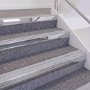 Mirrorflect Silver double insert chevron stair nosing, 60mm riser with Polar Grey inserts, fitted on carpeted stairs
