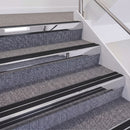 Mirrorflect Silver double insert chevron stair nosing, 60mm riser with Premium Black inserts, fitted on carpeted stairs
