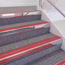 Mirrorflect Silver double insert chevron stair nosing, 60mm riser with Red inserts, fitted on carpeted stairs