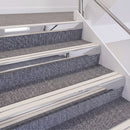 Mirrorflect Silver double insert chevron stair nosing, 60mm riser with White inserts, fitted on carpeted stairs