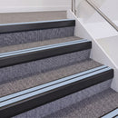 Satin Black double insert chevron stair nosing, 60mm riser with Aura inserts, fitted on carpeted stairs