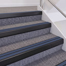 Satin Black double insert chevron stair nosing, 60mm riser with Blue inserts, fitted on carpeted stairs