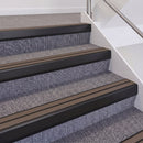 Satin Black double insert chevron stair nosing, 60mm riser with Brown inserts, fitted on carpeted stairs