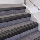 Satin Black double insert chevron stair nosing, 60mm riser with Dark Grey inserts, fitted on carpeted stairs