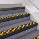 Satin Black double insert chevron stair nosing, 60mm riser with Hazard black and yellow inserts, fitted on carpeted stairs