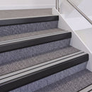 Satin Black double insert chevron stair nosing, 60mm riser with Polar Grey inserts, fitted on carpeted stairs