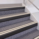 Satin Black double insert chevron stair nosing, 60mm riser with White inserts, fitted on carpeted stairs