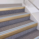 Satin Bronze double insert chevron stair nosing, 60mm riser with Aura inserts, fitted on carpeted stairs