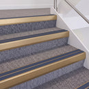 Satin Bronze double insert chevron stair nosing, 60mm riser with Blue inserts, fitted on carpeted stairs